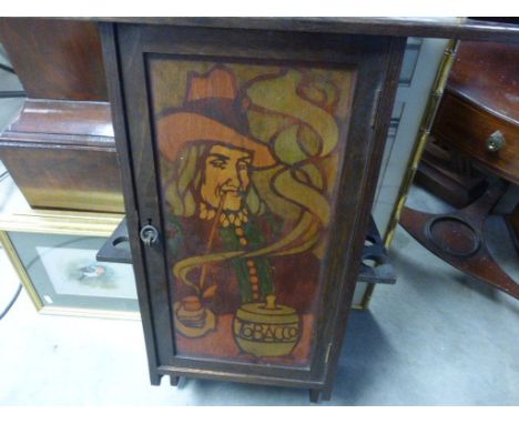 An Arts & Crafts Liberty Co hanging smoking cabinet, the front panel decorated with a cavalier smoking a pipe with a tobacco 