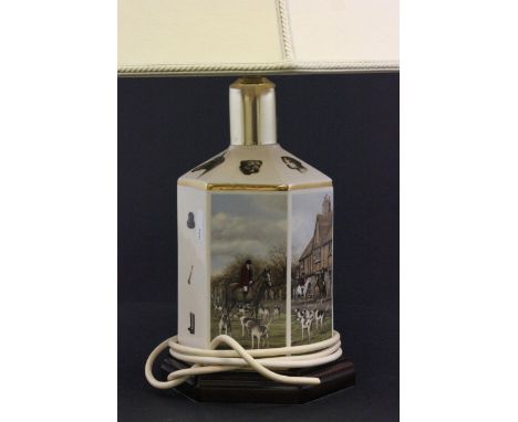 A contemporary table lamp decorated with fox hunting panels