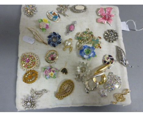 Group of decrotive brooches on  a cushion