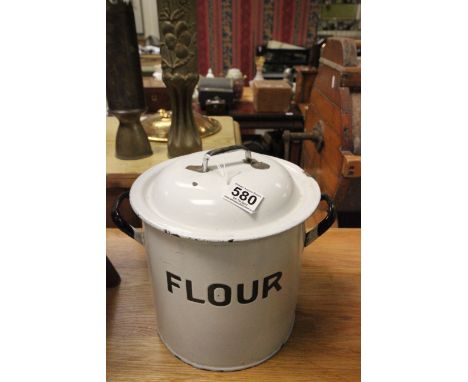 A vintage white enamel kitchen flour tin