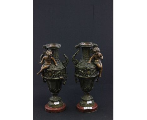 Pair of 19th Century French candlestick vases with cherubs on marble bases