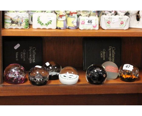Seven Caithness glass paperweights plus 2 related booklets
