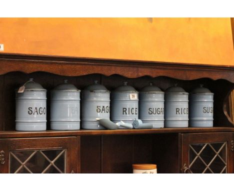 A set of 7 vintage blue enamel kitchen containers, along with two matching shovels