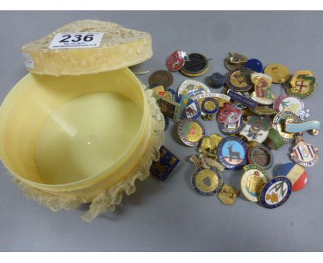 A quantity of Masonic and other enamel badges and brooches in a vintage powder box