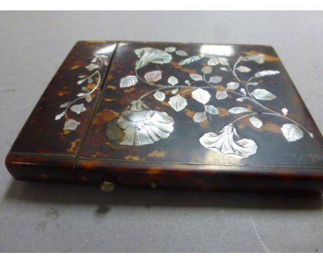 A 19th century tortoiseshell card case with floral mother of pearl decoration