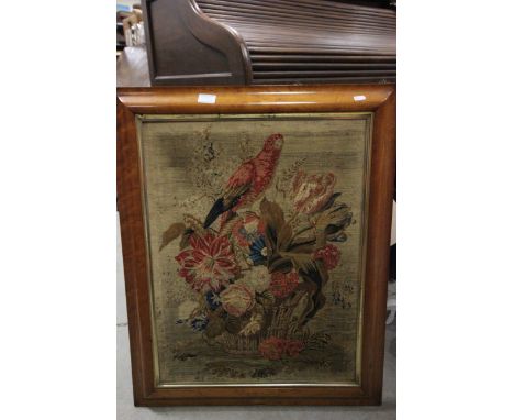 A 19th century wool work tapestry of a parrot in a floral setting contained within a antique maple frame