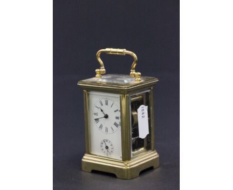 A miniature enamel faced brass cased striking carriage clock with alarm 