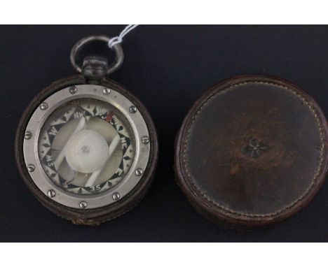 A vintage steel cased compass with leather case which is stamped with a Fleur de lis motif
