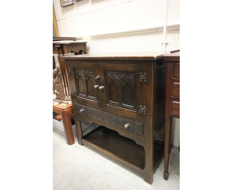 Small Oak Cupboard with two carved panel doors over drawer and shelf below