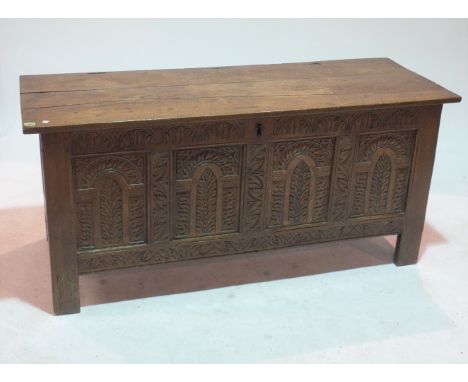 AN 18TH CENTURY OAK COFFERWith carved panel decoration, 148cm wide; 68cm high54cm deep old marks and scratches all over, two 