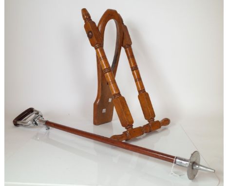 A LATE VICTORIAN TURNED BEECH FOLDING BOOT JACK (2)Folding uu-right, 53.5cm high; Together with a shooting stick