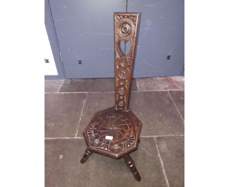 An oak spinner's chair with Celtic style carved back, height 87cm. 