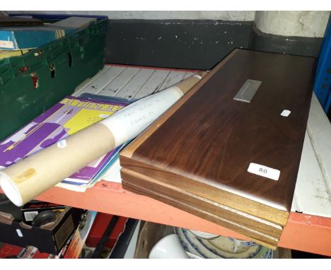 A wooden display box with 50 small spaces for ingots and a first edition signed by Leonard Cheshire of a Lancaster Bomber 