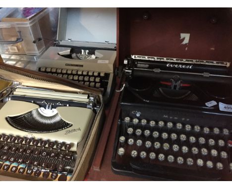 An Everest portable typewriter, a Kolibri, and a Boots portable typewriter 