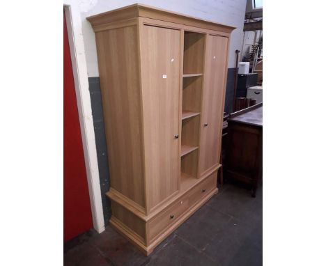 A modern light oak effect wardrobe, width 133cm, depth 59cm &amp; height 195cm. 