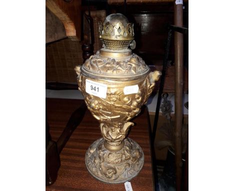 A guilt spelter oil lamp with colonial sceneCondition: crack to stem of base creating an overall lean, crack and repair to in