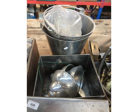 2 stainless steel buckets and a tin containing industrial light shades