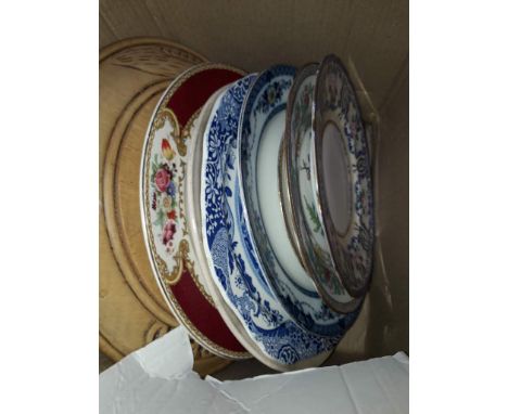 Small box of pottery plates and a wooden bread board 