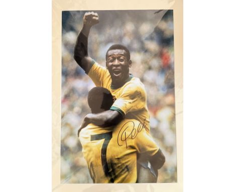 Football. Pele Signed 33x23 Colour printed photo. Photo, Matted. Photo shows Pele being lifted in the air triumphantly by a f