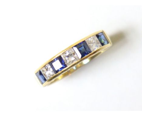 A sapphire &amp; diamond half-hoop ring set four rectangular-cut sapphires separated by three round-cut diamonds, to an 18ct 