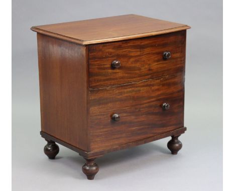 A Victorian bow-front chest commode with hinged lift-lid &amp; turned wooden handles to the mock drawer-fronts, on four turne