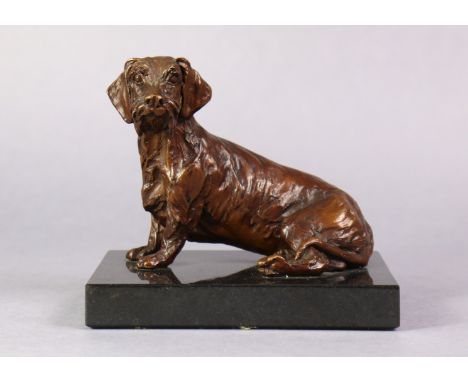 SARAH COWARD (contemporary).  A cast bronze sculpture of the dachshund “Teckel”, edition 119, signed, seated on black granite
