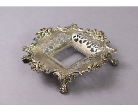 A Victorian silver square inkstand with pierced scroll sides &amp; cast floral rim, on four cast lion-paw feet, 6½” wide; She