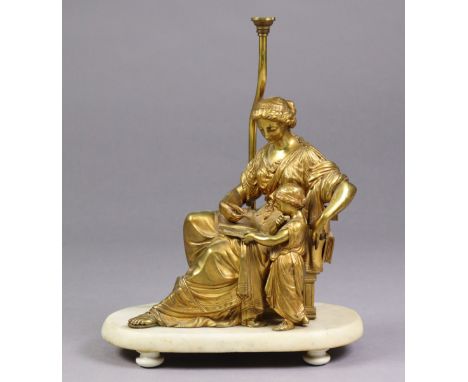 A 19th century French ormolu group of a mother &amp; child with an open book, 10½” high x 10” wide, later mounted on white ma