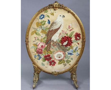 A 19th century giltwood &amp; gesso large oval firescreen, inset petit-point needlework of a bird perched on a flowering bran