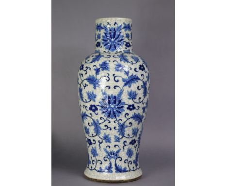 An early 20th century Chinese porcelain large baluster vase, painted in underglaze blue with trailing lotus flowers in relief