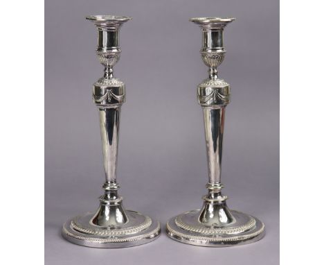 A pair of George III style plated candlesticks, 11” high; a plated Fiddle, Thread &amp; Shell soup ladle; a Fiddle pattern di