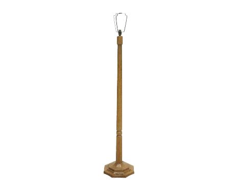 Workshop of Robert Mouseman Thompson (Kilburn): An English Oak Standard Lamp, octagonal column and base, with carved mouse tr