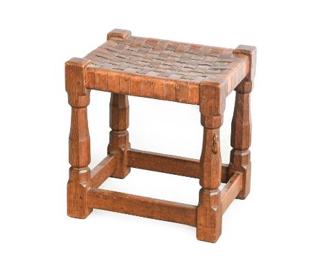Robert Mouseman Thompson (1876-1955): An English Oak Stool, strap leather top, on four octagonal legs joined by stretchers, w