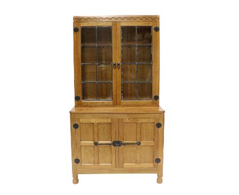 Workshop of Robert Mouseman Thompson (Kilburn): An English Oak Drinks Display Cupboard, the leaded glazed upper section with 
