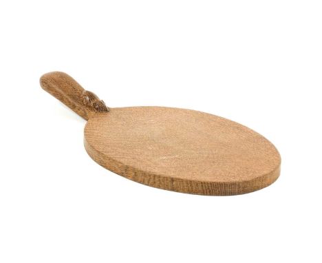 Workshop of Robert Mouseman Thompson (Kilburn): An English Oak Cheese Board, post 1960, of standard form, with carved mouse t