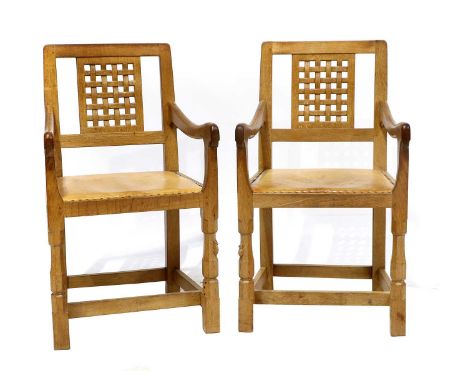 Workshop of Robert Mouseman Thompson (Kilburn): Two English Oak Lattice Back Arm Chairs, 1978, tan leather upholstered seats,