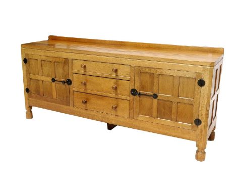 Workshop of Robert Mouseman Thompson (Kilburn): An English Oak 6ft Sideboard, 1969, with raised upstand, adzed top over two c