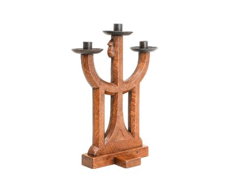 Robert Mouseman Thompson (1876-1955): An English Oak Triple Candelabra, 1939, with wrought iron sconces, cross base, with car