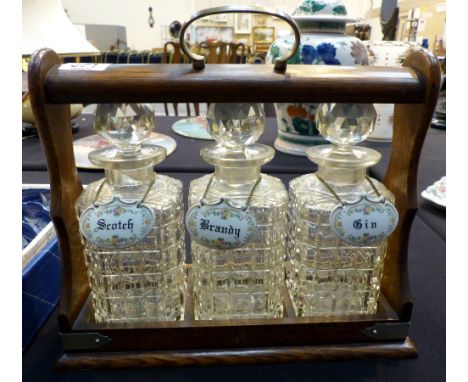 Three bottle tantalus with ceramic lablels
