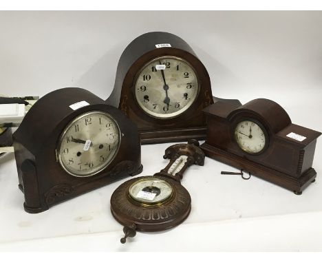 An inlaid Mahogany late Edwardian mantel clock, a small walnut barometer and two other clocks. (4)