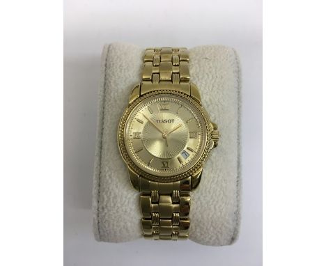 A boxed gold tone Tissot ladies watch with date and bracelet strap.