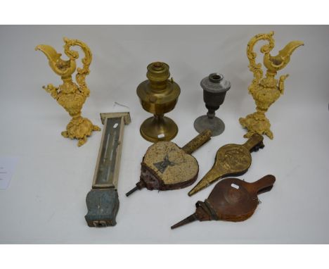 An antique wall barometer, three bellows and two oil lamps.