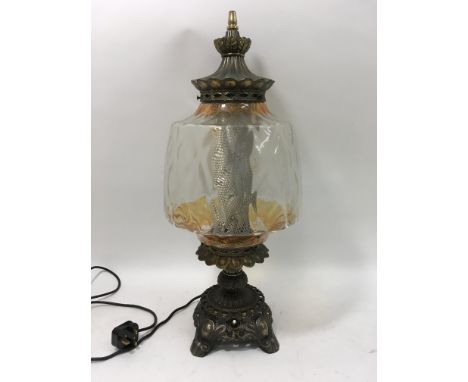 A metal and glass electric lamp height 26 inches with shade.