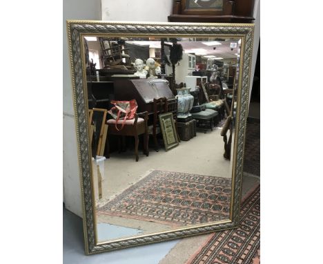 A large wall hanging mirror with framed surround. Height 54 inches, width 41 inches including frame.
