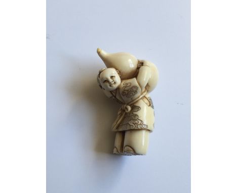 A Japanese Ivory carved Netsuke of the Meiji period 19th Century. In the form of a figure caring a double gourd bottle signed