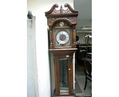 A 20th century Mahogany longcase clock with three train visible brass tube weights