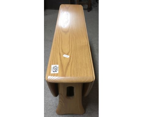 A light elm Ercol drop leaf occasional table