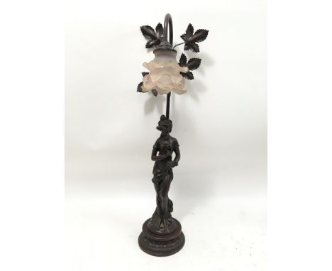 A reproduction lamp in the figure of a young maiden. Complete with pink glass shade. Height 26 inches.