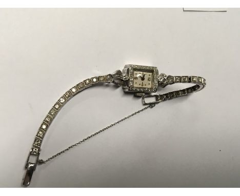 A lady's Vintage 14ct white gold and diamond set cocktail watch, of rectangular shape, set with diamonds the strap with diamo