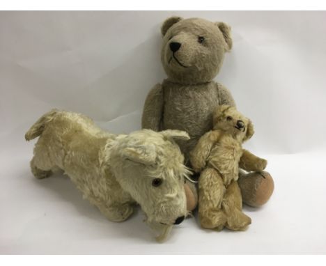 A vintage 1950's bear possibly a Steiff, a Steiff dog with original Steiff stud and one other small bear (3).